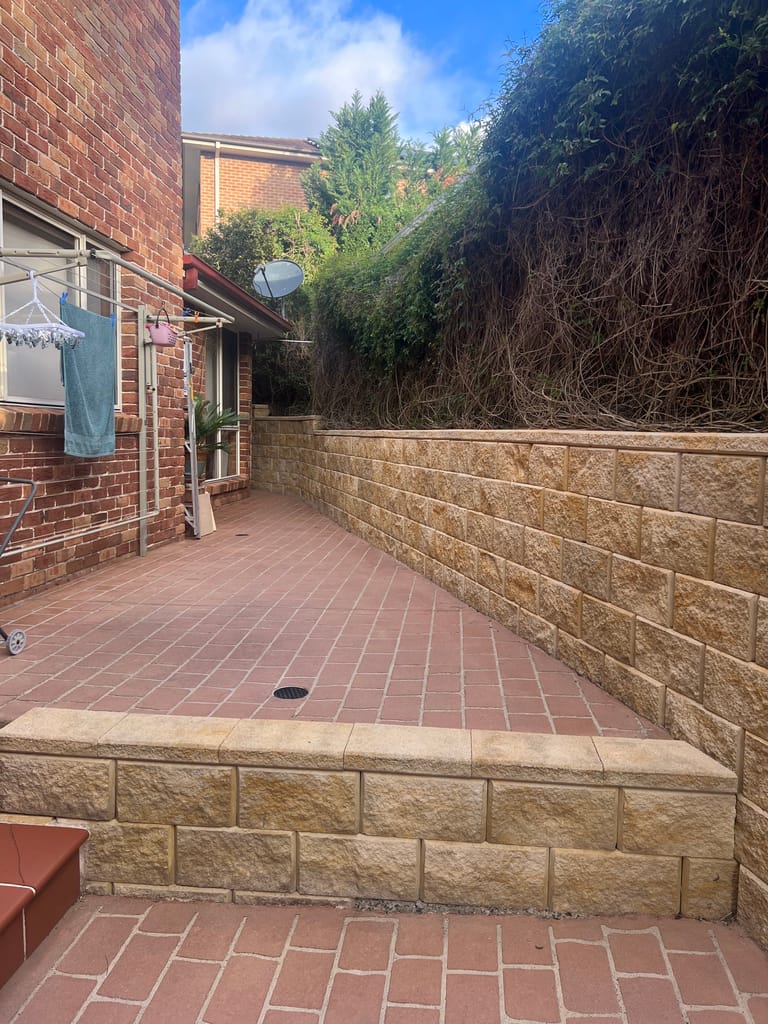 The same rendered wall, clean and bright after soft washing